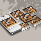 Phone displaying a food delivery app with printed menus on a table