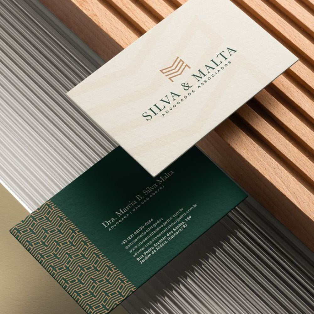 Two business cards with Silva & Malta branding on a textured surface