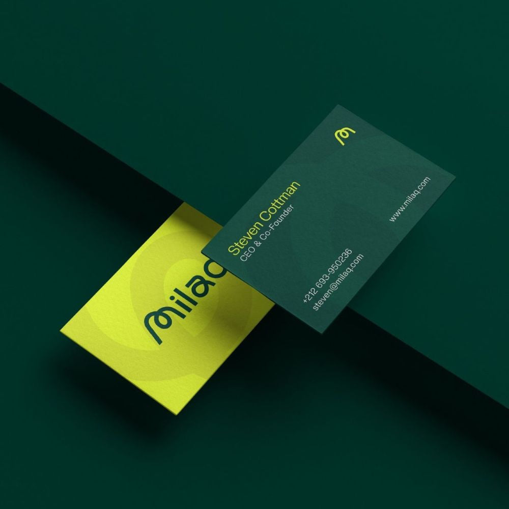 Two business cards with 'milad' branding on a dark green background
