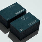 Stacks of Heleven business cards on a light gray background