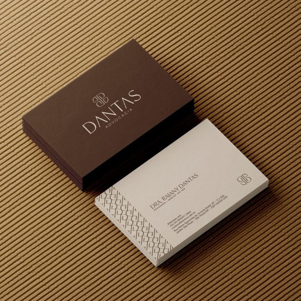 Dantas business card on a textured brown surface