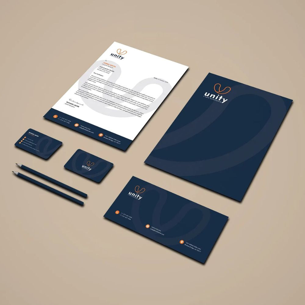 Stationery set with 'unity' branding on a beige background