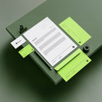 Stationery items including a letter, business card, and sticky notes on a green surface.