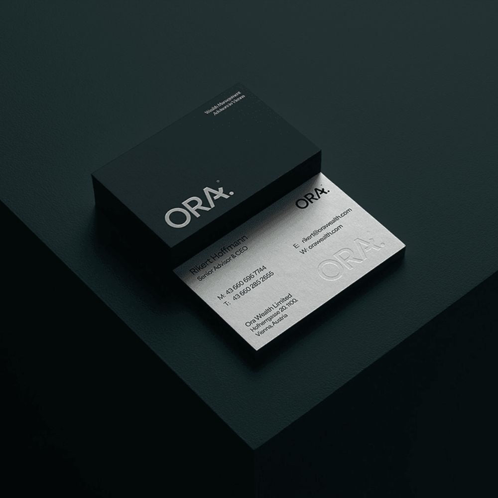 ORA business card and box on a dark background