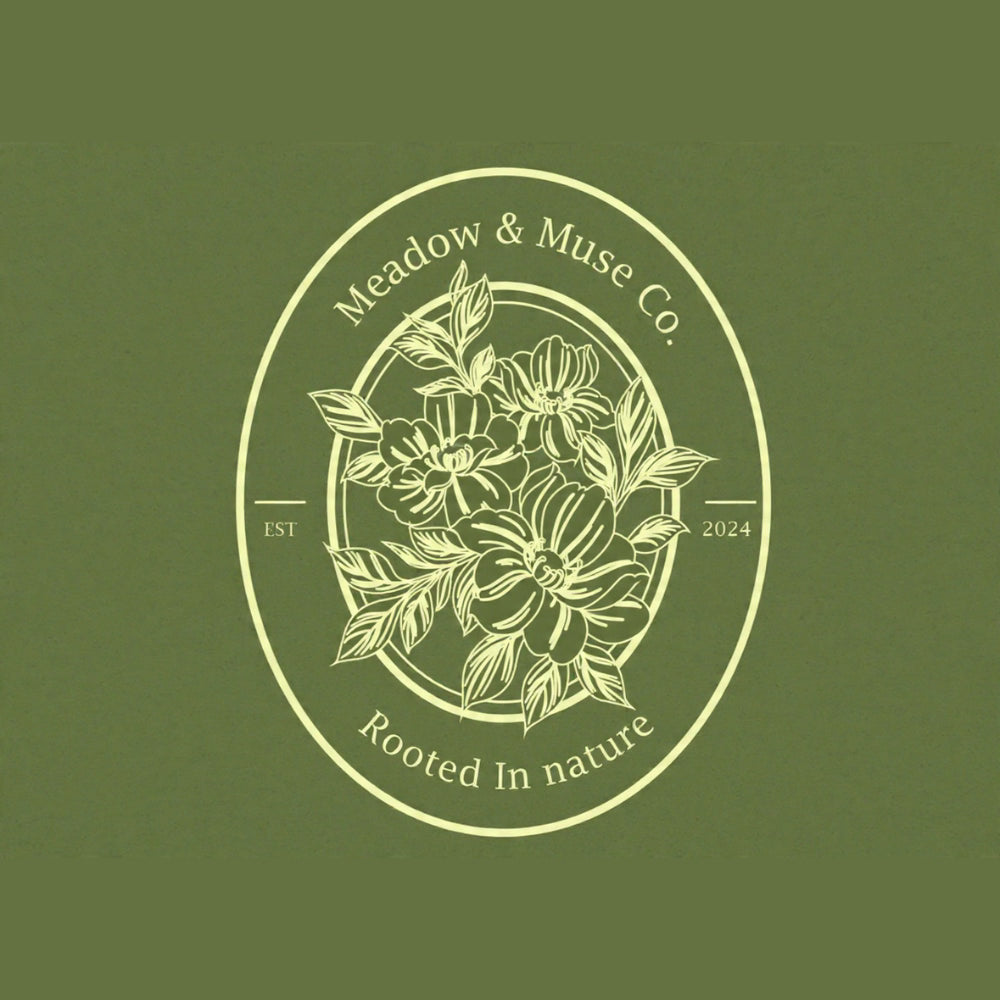 Logo of Meadow & Muse Co. with floral design on a green background